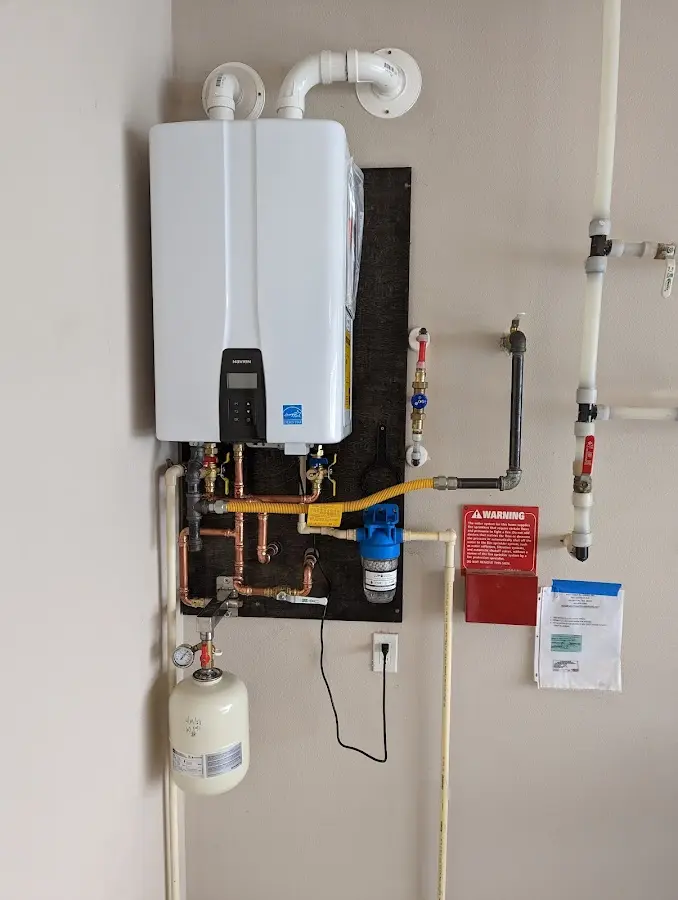 Professional plumber installing copper piping in a Vandalia home